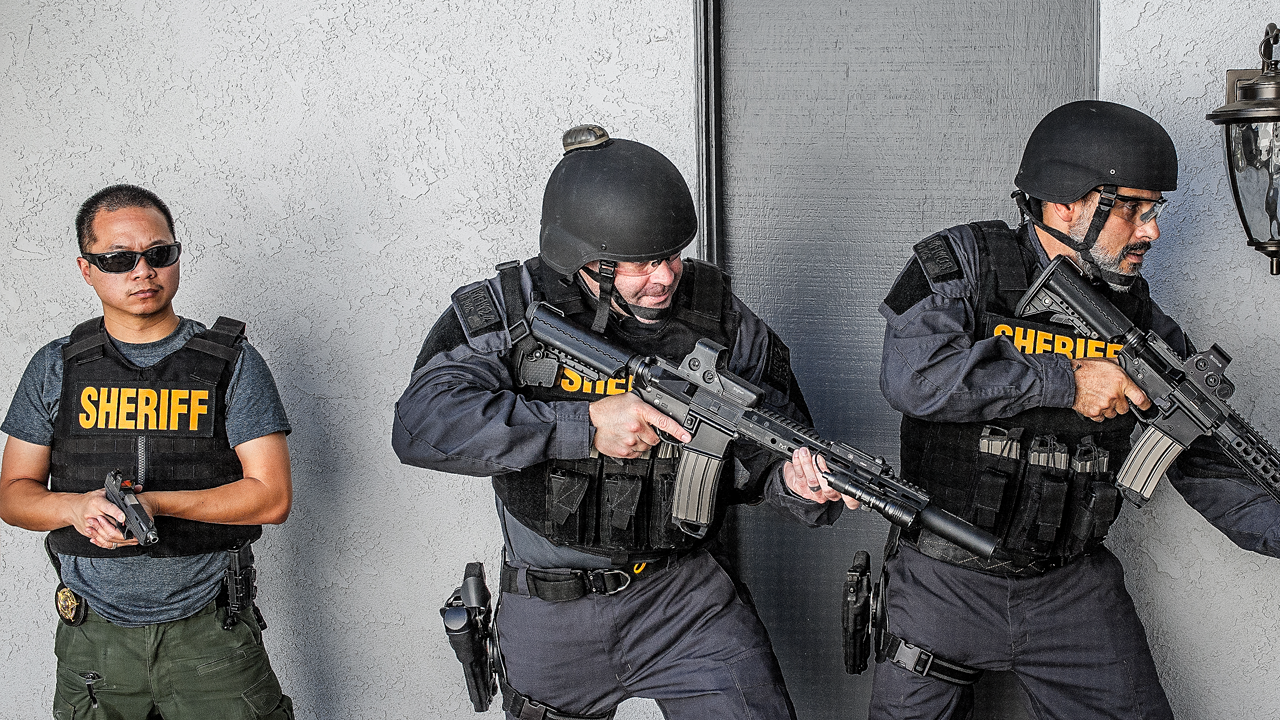 Law enforcement officers fully kitted in body armor