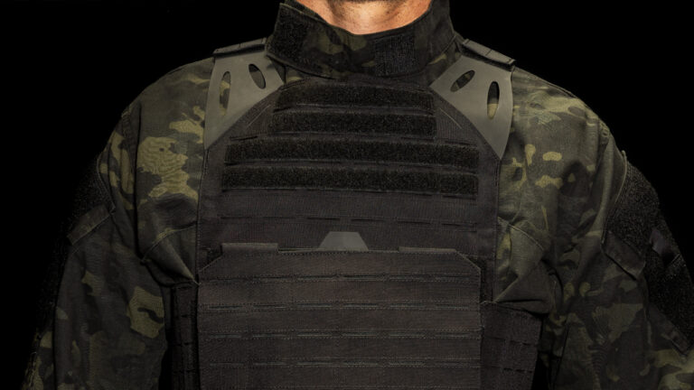 Model wearing Trooper LVPC Low Vis Plate Carrier Black front view hero image on blog post